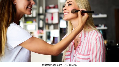 Makeup Artist Applying Liquid Tonal Foundation On The Face Of The Woman In Make Up Room