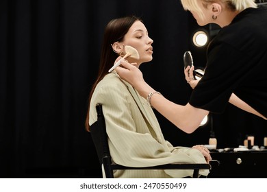 Makeup artist applying makeup on a womans face. - Powered by Shutterstock