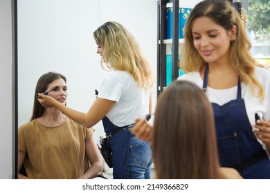 Makeup Artist Applying Sculpting And Setting Gel On Eyebrows Of Young Female Client