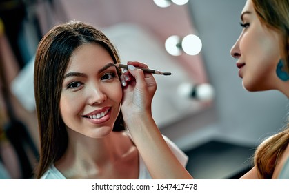 Makeup artist in beauty studio working with beautiful asian makeup model - Shutterstock ID 1647417478