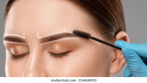 Make-up Artist Makes Markings With White Pencil For Eyebrow And Paints Eyebrows. Professional Makeup And Facial Care.