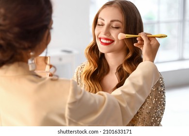 Makeup Artist Working With Beautiful Model In Beauty Salon