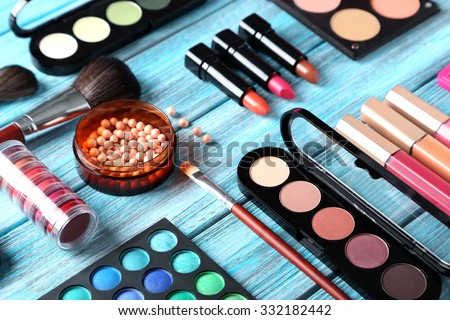 Makeup brush and cosmetics on blue wooden table Foto stock © 