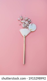 Makeup Brush And Crushed Powder Highlighter Bronzer On Pink Background. Top View.