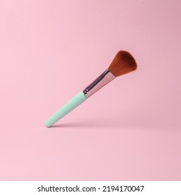 makeup brush flying in antigravity on pink background with shadow. Levitation object in the air. Beauty and fashion concept. Creative minimalist layout - Powered by Shutterstock