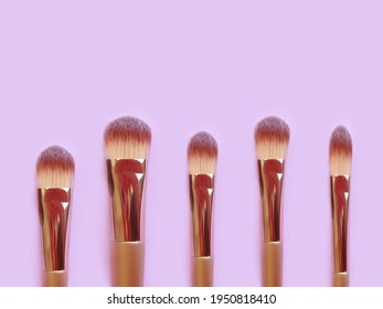 makeup brush on colored background