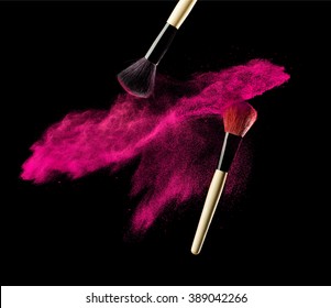 Make-up Brush With Pink Powder Explosion On Black Background