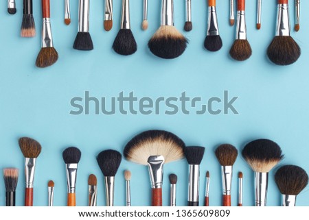 Makeup brush set, professional makeup tools, brushes for different functions on ligth-blue background