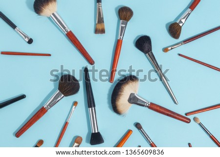 Makeup brush set, professional makeup tools, brushes for different functions on ligth-blue background
