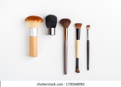 Makeup brushes of different sizes on a white background