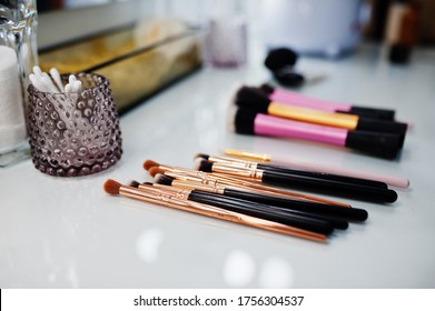 Makeup Brushes On White Gloss Table On Make Up Saloon.