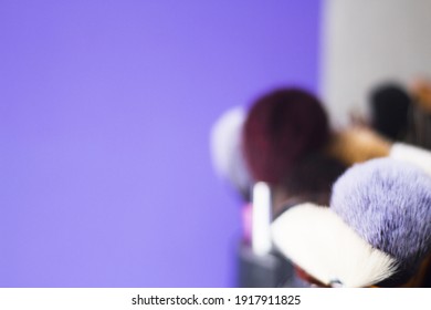 Makeup Brushes Somewhat Out Of Focus On Bluish Background. No People