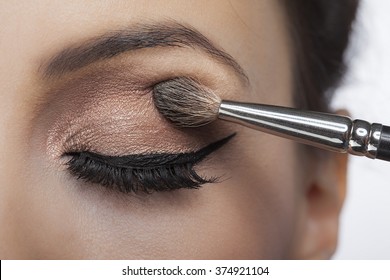 Makeup close-up. Eyebrow makeup, long eyelashes, brush.
