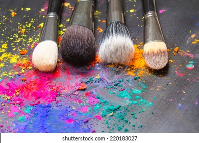 Makeup Concept. Makeup Brushes On A Background With Colorful Powder