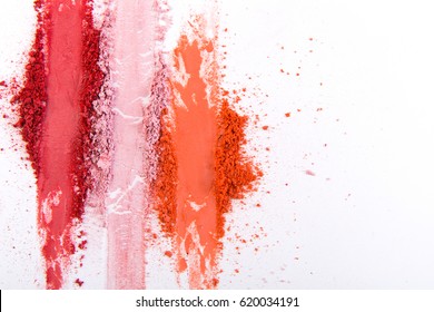 Makeup cosmetics. Blush crushed palette strokes, colorful powder on white background, art of make-up