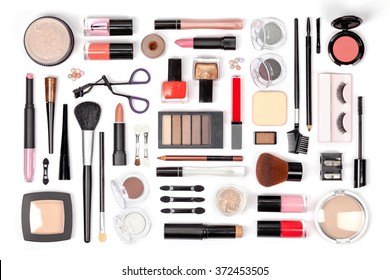 makeup cosmetics, brushes and other essentials on white background top view. beauty flat lay concept in red colors