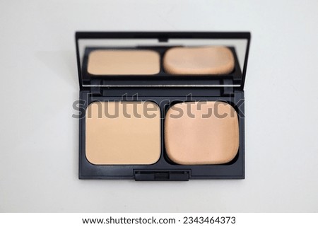 Makeup face powder isolated on white background, powder box and powder sponge complete with mirror