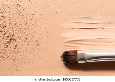 Makeup Foundation Background With Beige Liquid Foundation Texture, Skin Tone Concealer Smudges, Nude Face Powder And Cosmetic Makeup Brush