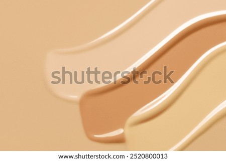Makeup foundation cream texture background. Beige concealer, BB cream smears