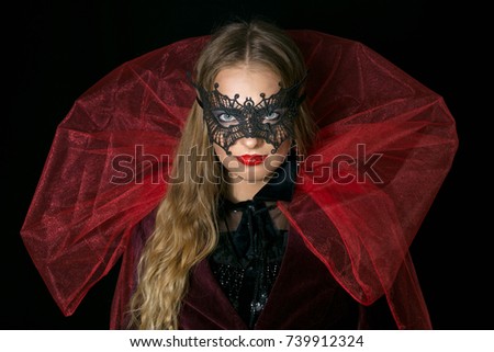 make-up girl witch on halloween costume in black mask