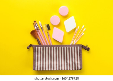 Makeup Kit. Female Makeup Brushes In A Cosmetic Bag On A Yellow Bright Background. Women Things. Top View