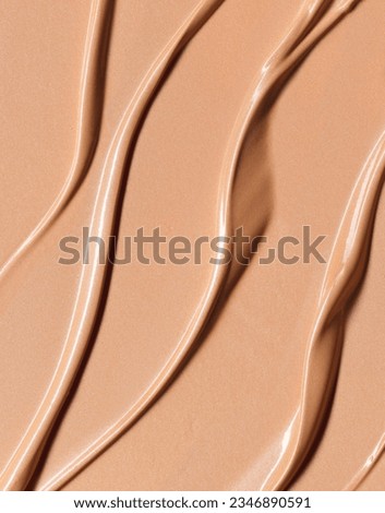 Makeup Liquid foundation composition background. BB CC Cream Concealer texture. Cosmetic product brush swatch
