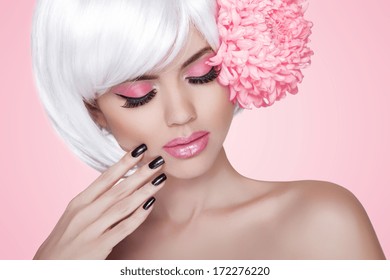 Makeup. Manicured nails. Fashion Beauty Model Girl portrait with Flower. Treatment. Beautiful Blonde Woman over pink background