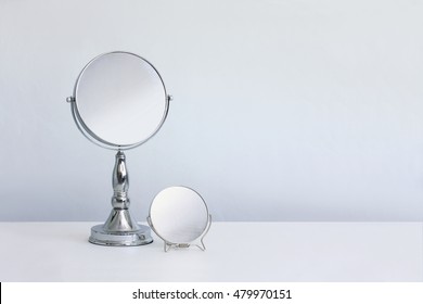 Makeup mirror with magnifying glass. Cosmetic objects.
