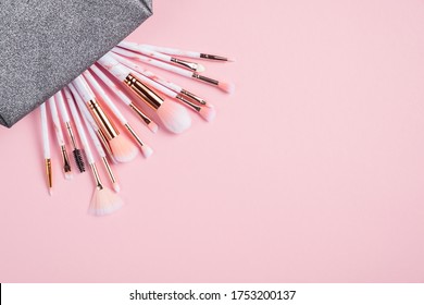 Makeup Pouch With Collection Of Brushes On Pink Background, View From Above. Make Up Store Banner Mockup.