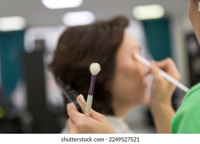 Makeup process, make-up artist paints model in salon - Shutterstock ID 2249527521