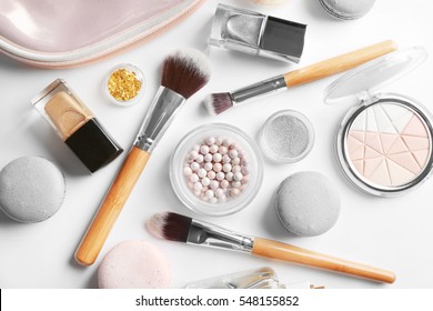 Makeup products with cosmetic bag and macaroons on light background - Shutterstock ID 548155852