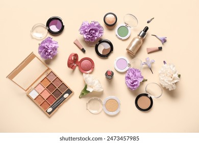 Makeup products with flowers on beige background