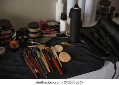Makeup products and tools on a table in a beauty salon.