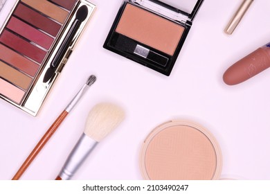 Makeup set on a white background.Eyeshadow palette , powder, blush, lipstick, pencil, brushes 