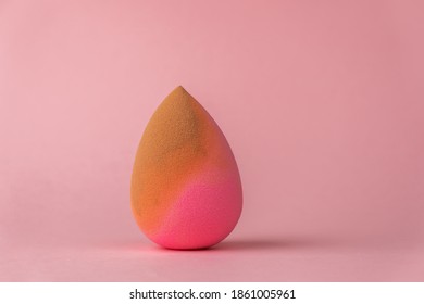 Makeup Sponge That Was Used To Apply Foundation Or Bb Cream On A Pink Background.