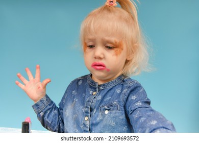 Make-up Was Taken Away From The Little Girl With Makeup And She Throws Up Her Hands In Displeasure.