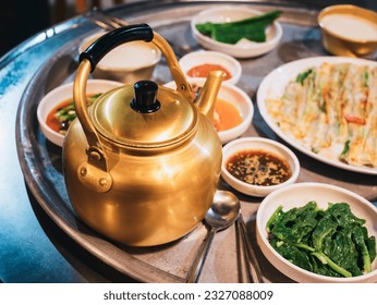 Makgeolli drink with Korean traditional food Pajeon on table Local Restaurant Korea travel  - Shutterstock ID 2327088009