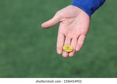 Makhachkala, Russia - March 9, 2019:  Football Referee Equipment, UEFA Yellow Coin Toss. Coin For The Toss.
