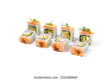 Maki Sushi With Baked Salmon Outside, Avocado And Crab Meat Inside Topped Micro Greens. Grilled Salmon And Avocado Maki Roll Isolated On White Background. Trendy Sushi Roll With Burnt Salmon Fish