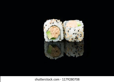 Maki Tuna Uramaki Sushi Isolated With Cooked Tuna, Avocado, Philadelphia Cheese And Sesame Seeds  On Black Background With Reflection In Front View