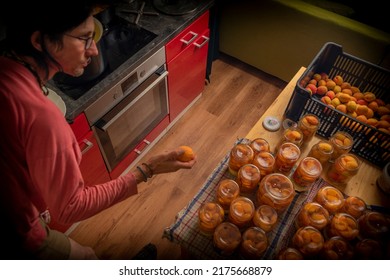 Making of apricot compote on wooden table interior middle of summer with male - Shutterstock ID 2175668879