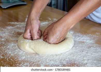 Making Artisan Bread Dough Over Wooden Bakers Table