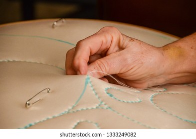 Making Baby Quilts.  Delicate Hands Take Care That Each Stitch Is Perfect. 