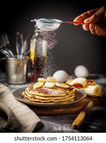 Making Banana Pancakes With Sugar Powder On The Table