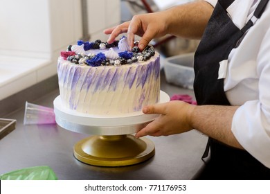 Making Of A Beautiful Cake. Baker Is Putting Decorated Berries On Top. Baking And Decorating Cakes For Wedding, Birthday Or Any Event.