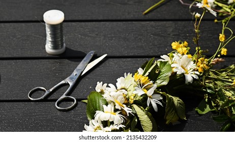 Making A Beautiful Flower Crown, Or Flower Wreath, Using Wire, Scissor And Wild Flowers. Photo Taken On Midsummer Eve, A Holiday In Sweden.