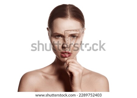 Making beauty, modifying face to make non-surgical or surgical correction, plastic surgery. correction of asymmetry. Young woman, female patient isolated on white studio background. Concept of lifting