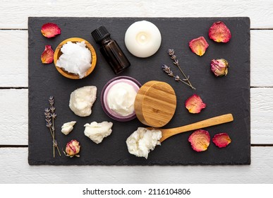 Making bodywhip also known as body butter, skin care moisturizer cream. Ingredients on wood background: shea butter,solid coconut oil, essential oils. Ready made body foam butter inside jar.