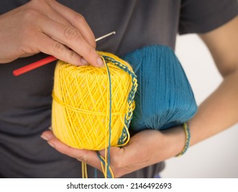 Making Bracelet - Woman's Hand Holding Blue And Yellow Yarn Ball, Colors Of Ukrainian Flag. - Close Up