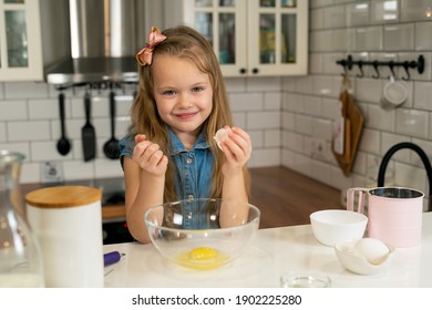 Making Breakfast, Kids. Smiling Girl Holding An Egg Shell In Her Hand.